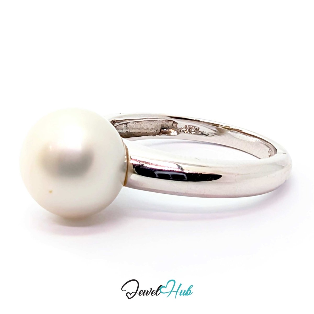 A sterling white gold ring featuring a single, round, lustrous white pearl on a clean white background.