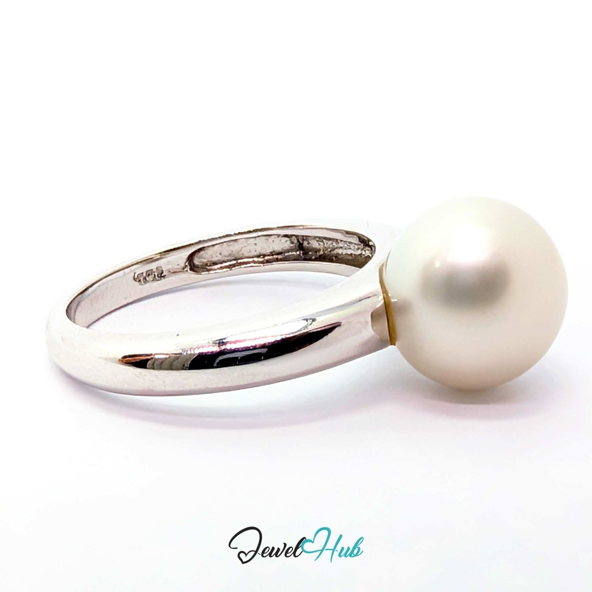 A white gold ring featuring a single large, round white pearl set on a plain white background. The brand name 'JewelHub' is visible as a watermark at the bottom.