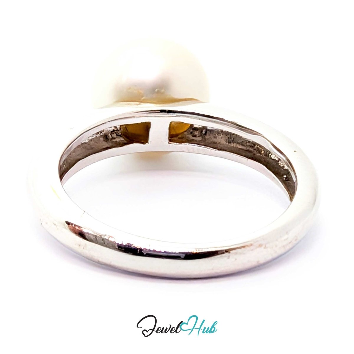 A white gold ring featuring a large, round, off-white pearl on a plain white background, with a 'JewelHub' watermark at the bottom.