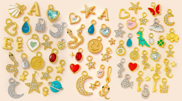 Collection of various gold and colorful charms on a beige background