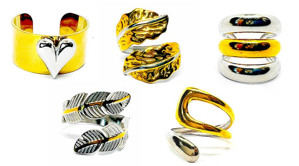 Collection of various gold and silver rings on a white background