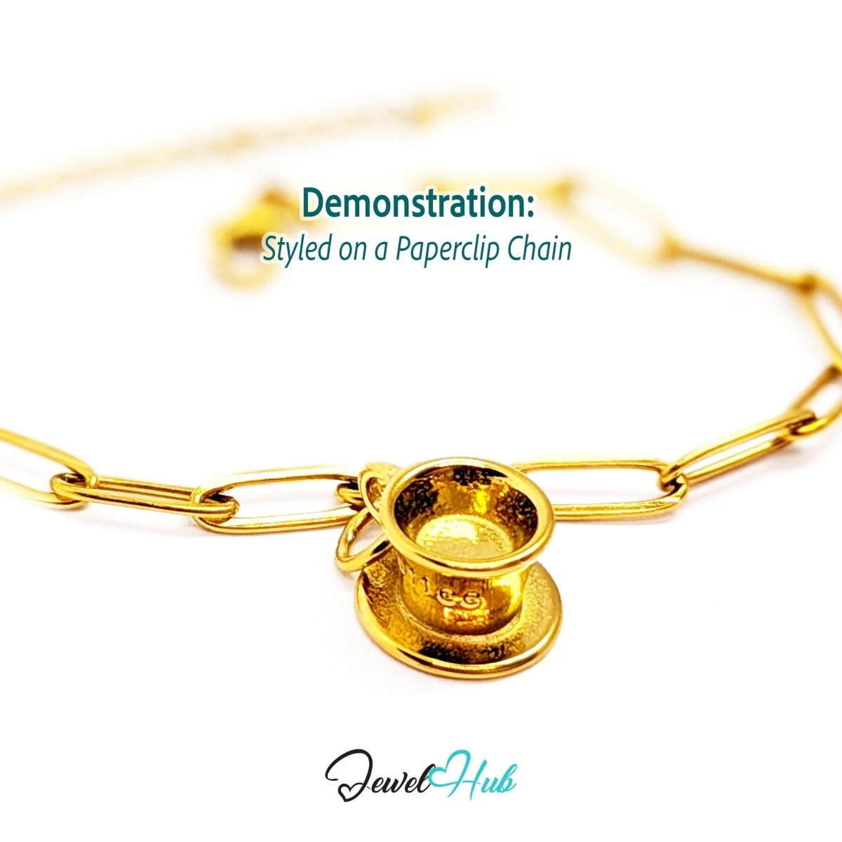 Three-dimensional coffee cup and saucer charm in gold stainless steel - styled on a gold paperclip chain bracelet - JewelHub