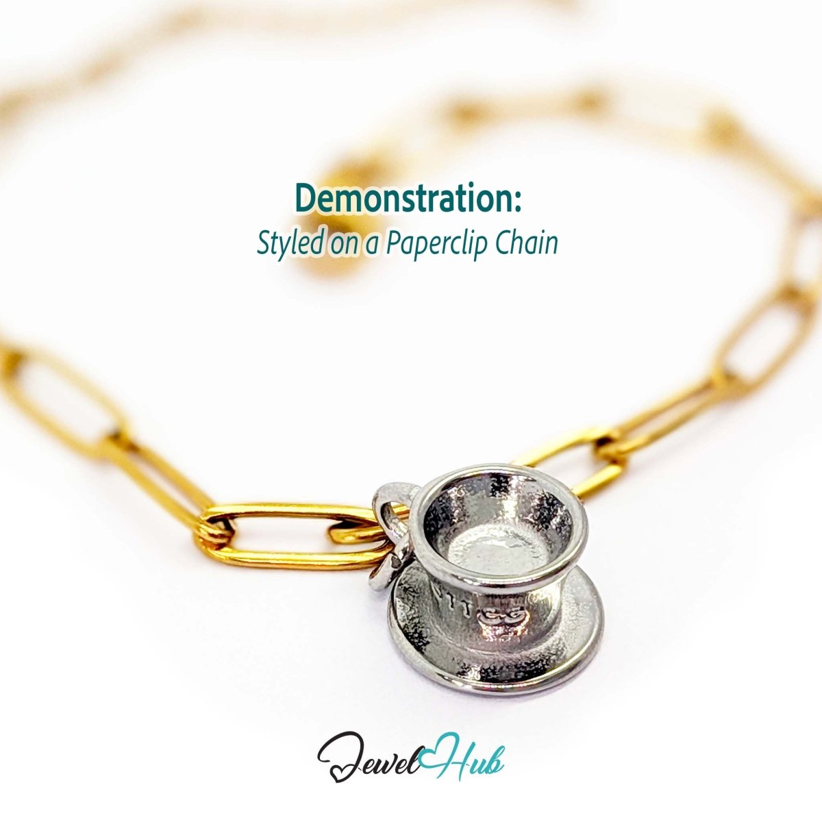 Three-dimensional coffee cup and saucer charm in silver stainless steel - styled on a gold paperclip chain bracelet - JewelHub