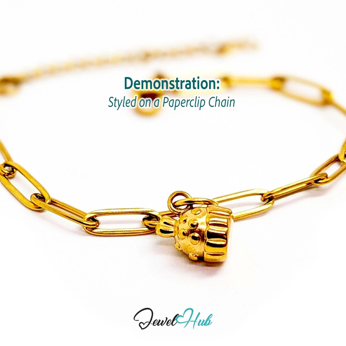 Three-dimensional cupcake charm in gold stainless steel - styled on a gold paperclip chain bracelet - JewelHub