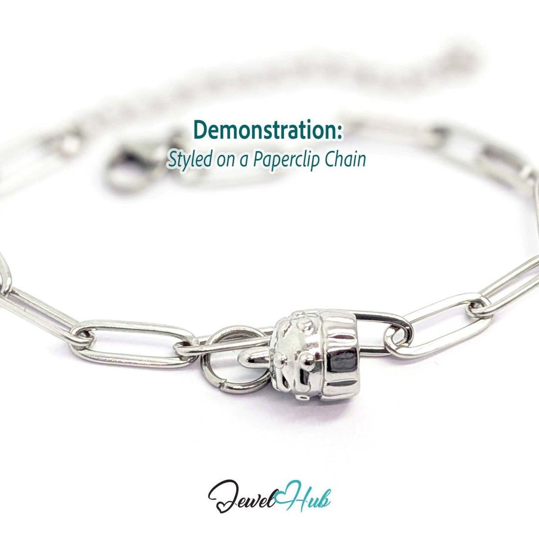 Three-dimensional cupcake charm in silver stainless steel - styled on a silver paperclip chain bracelet - JewelHub