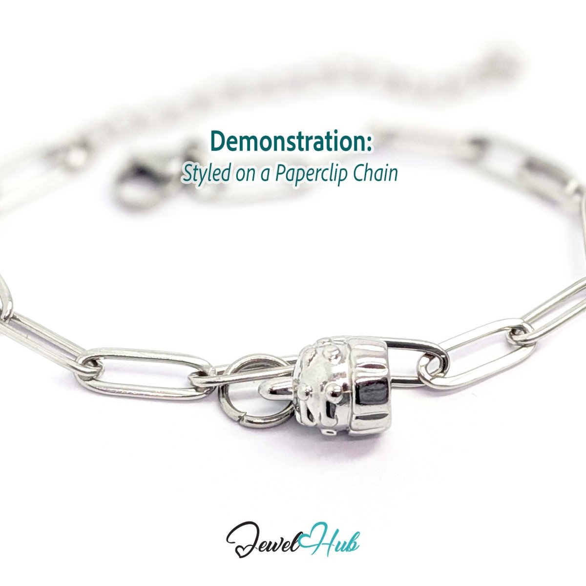 Three-dimensional cupcake charm in silver stainless steel - styled on a silver paperclip chain bracelet - JewelHub