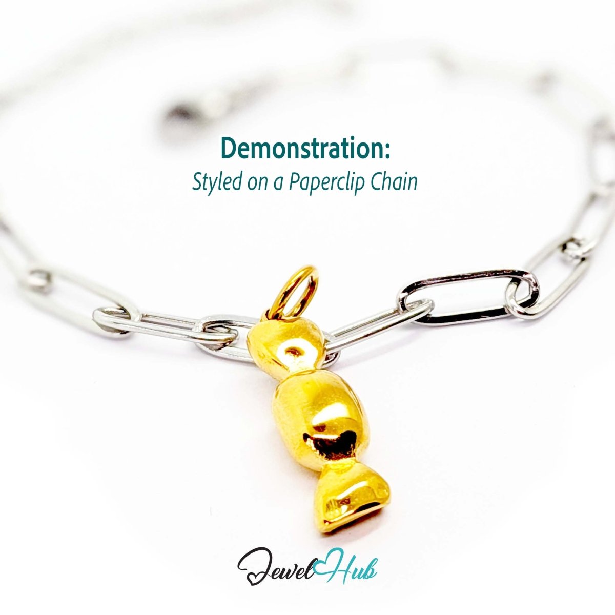 Wrapped sweet charm in gold stainless steel - styled on a silver paperclip chain bracelet - JewelHub