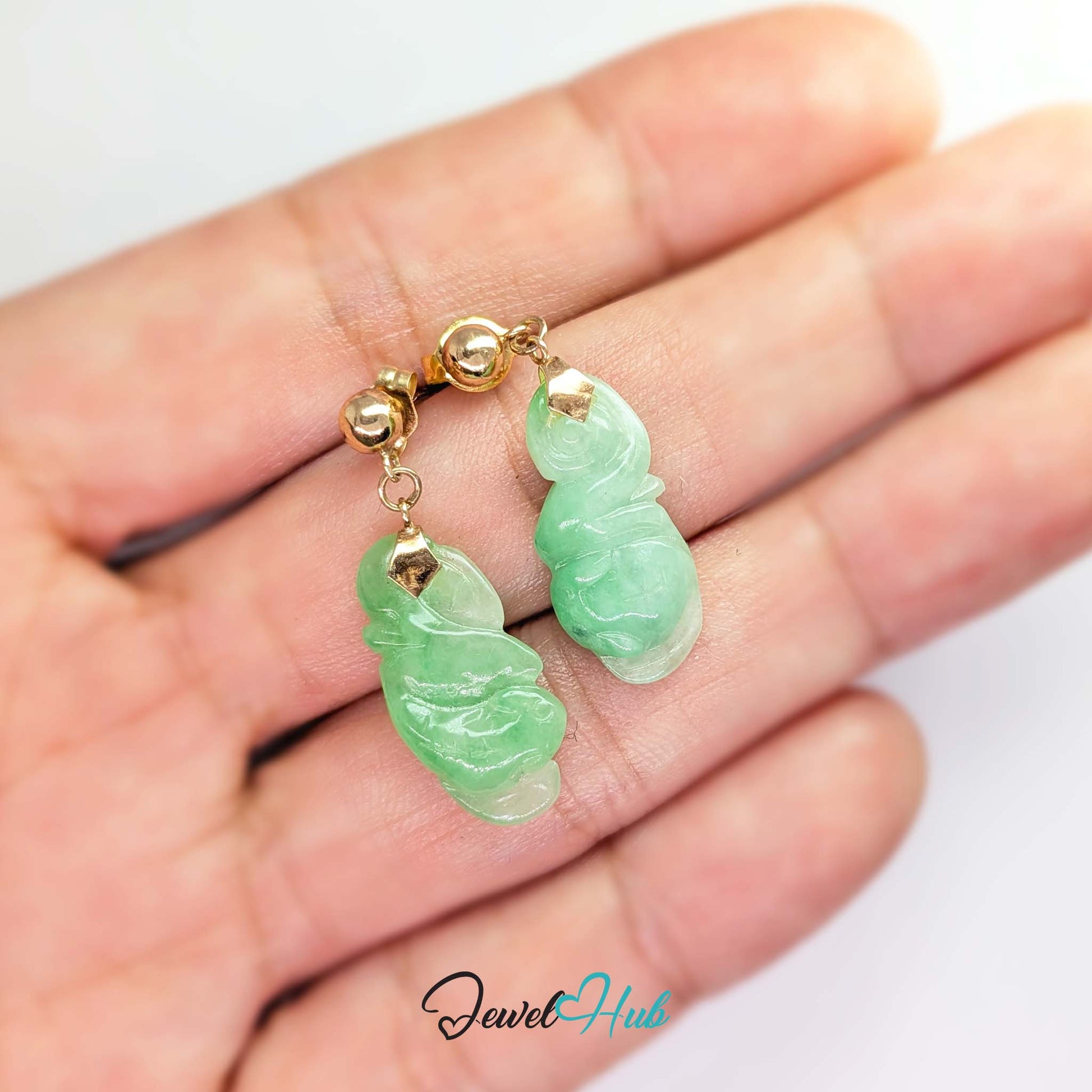 Vine tendril curling at the base of the carved apple green jade gourd - JewelHub