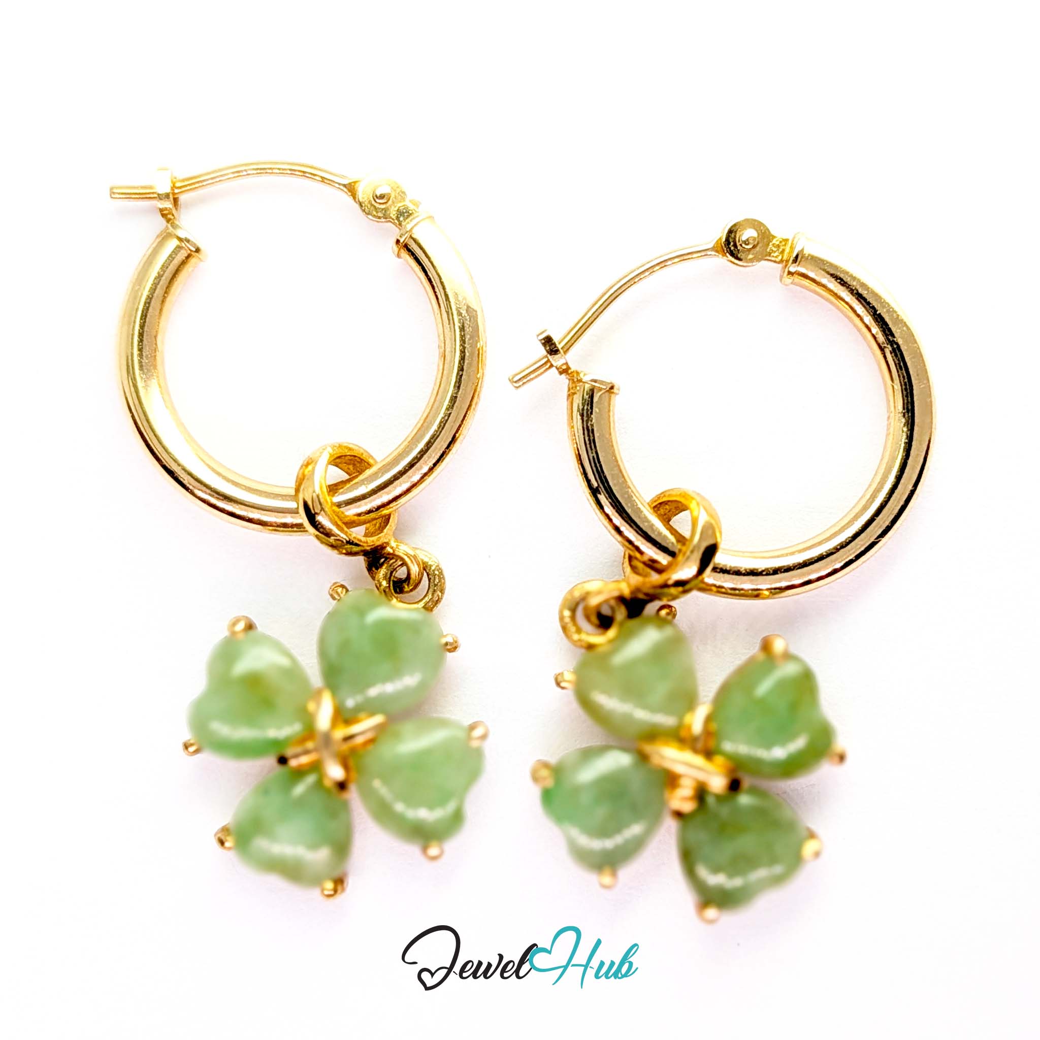 Clover charm swinging behind the ear, catching light from underneath - JewelHub