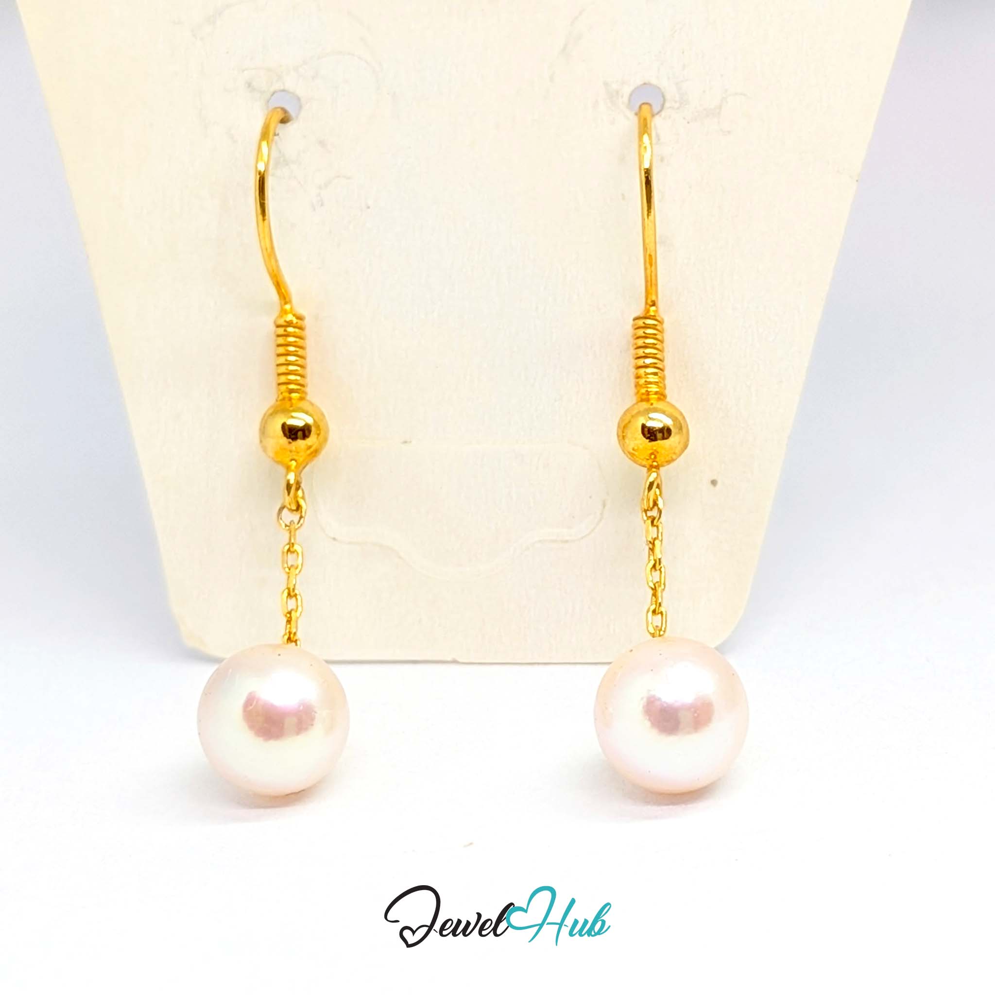 Pearl turning on its chain so the reflection travels across the surface - JewelHub