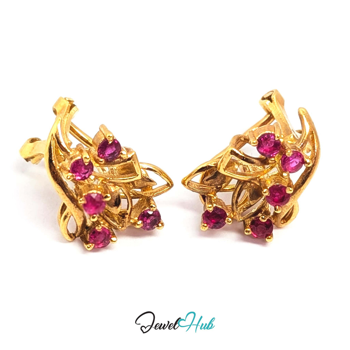 Openwork gold spray of ribbons, a leaf and a crossed stem holding five rubies - JewelHub