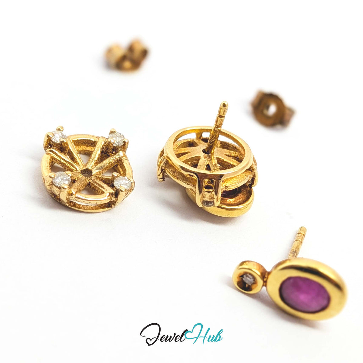 Fifth diamond bezel-set into the small gold ring at the top of the ruby drop - JewelHub
