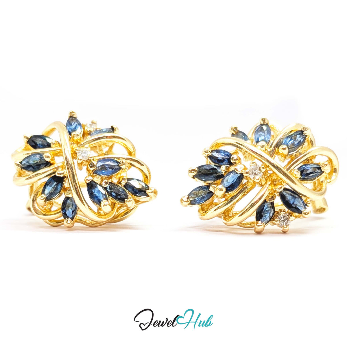 Interwoven gold ribbon crossing at the centre of the sapphire spray like a knot - JewelHub