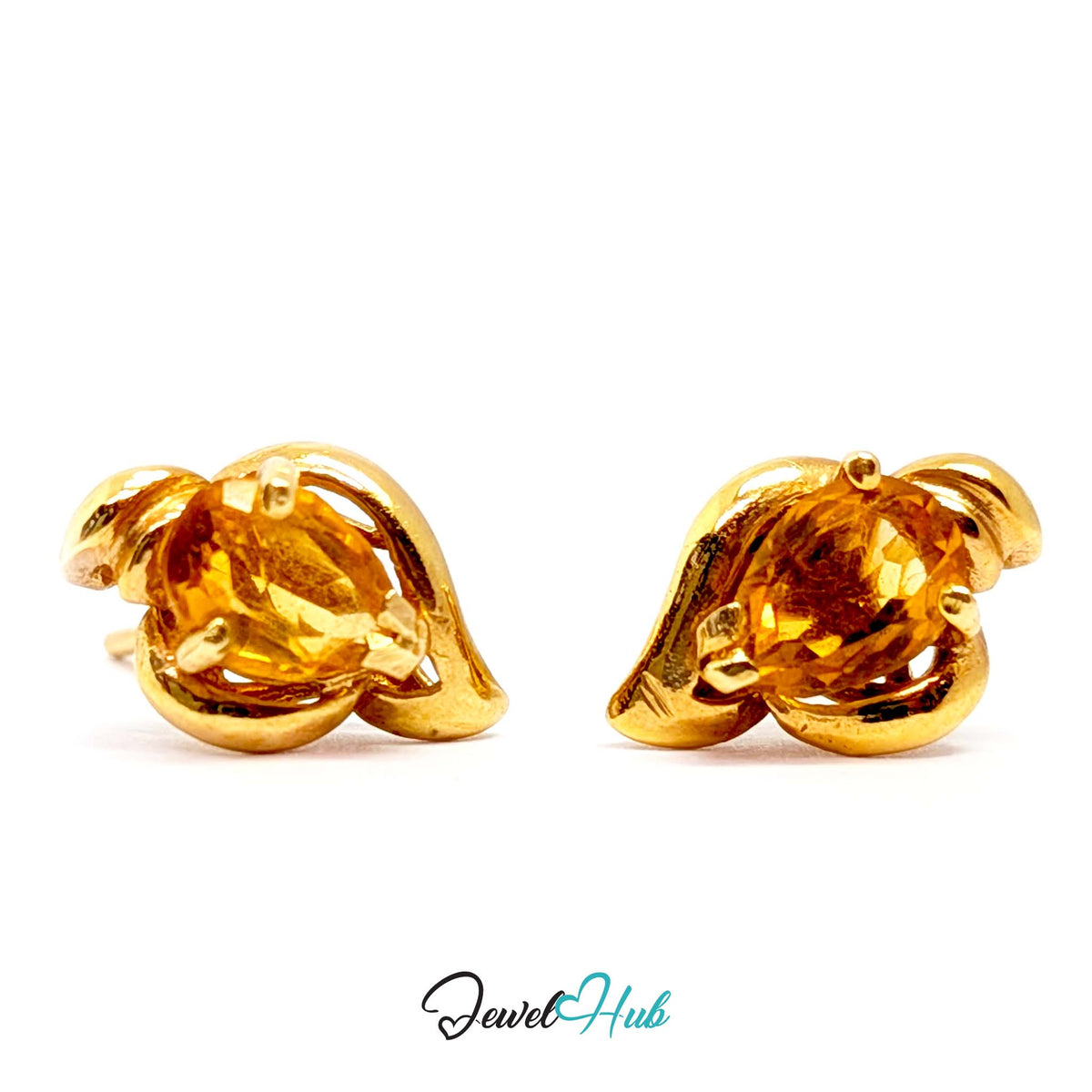 Warm golden orange citrine with amber depths in the faceted oval - JewelHub
