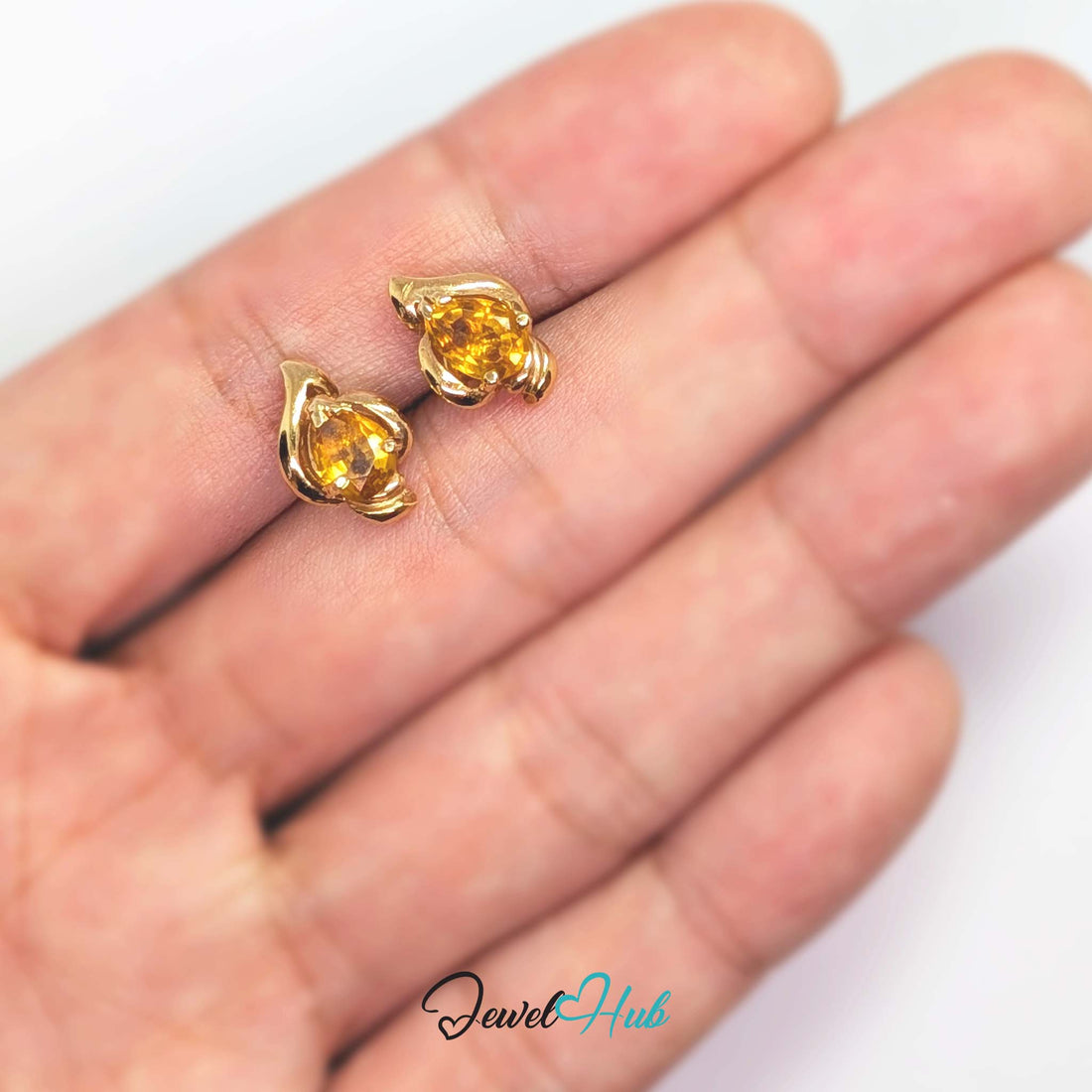 Heavy curl of polished gold folding around the citrine like a wave breaking - JewelHub