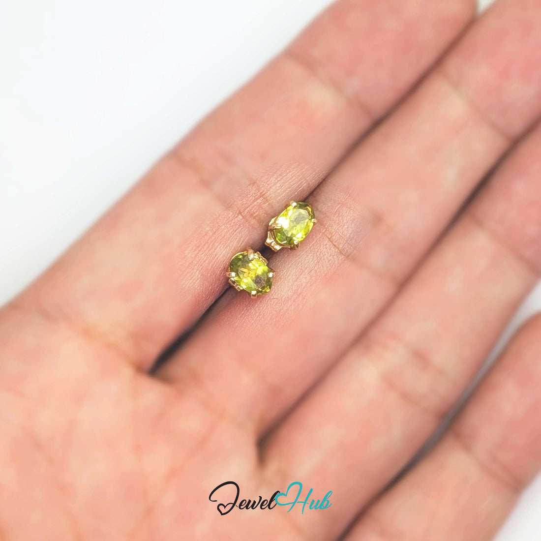 14K gold peridot stud earrings, oval yellow-green stones in plain four-claw settings - JewelHub