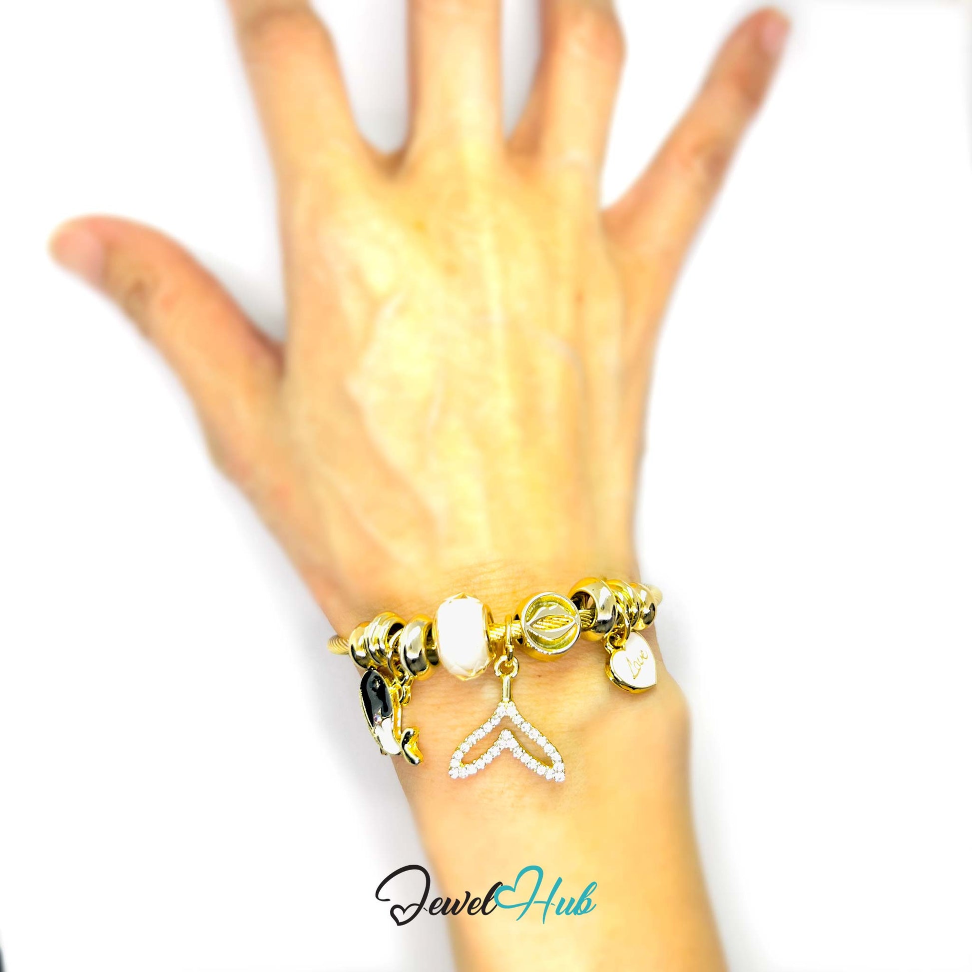 Gold bracelet with charms on a hand against a white background, branded 'Jewel Hub'.