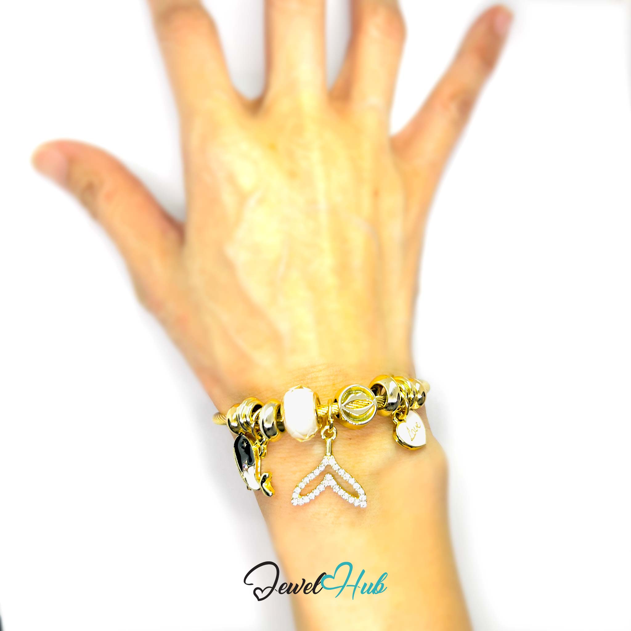 Gold bracelet with charms on a hand against a white background, branded 'Jewel Hub'.