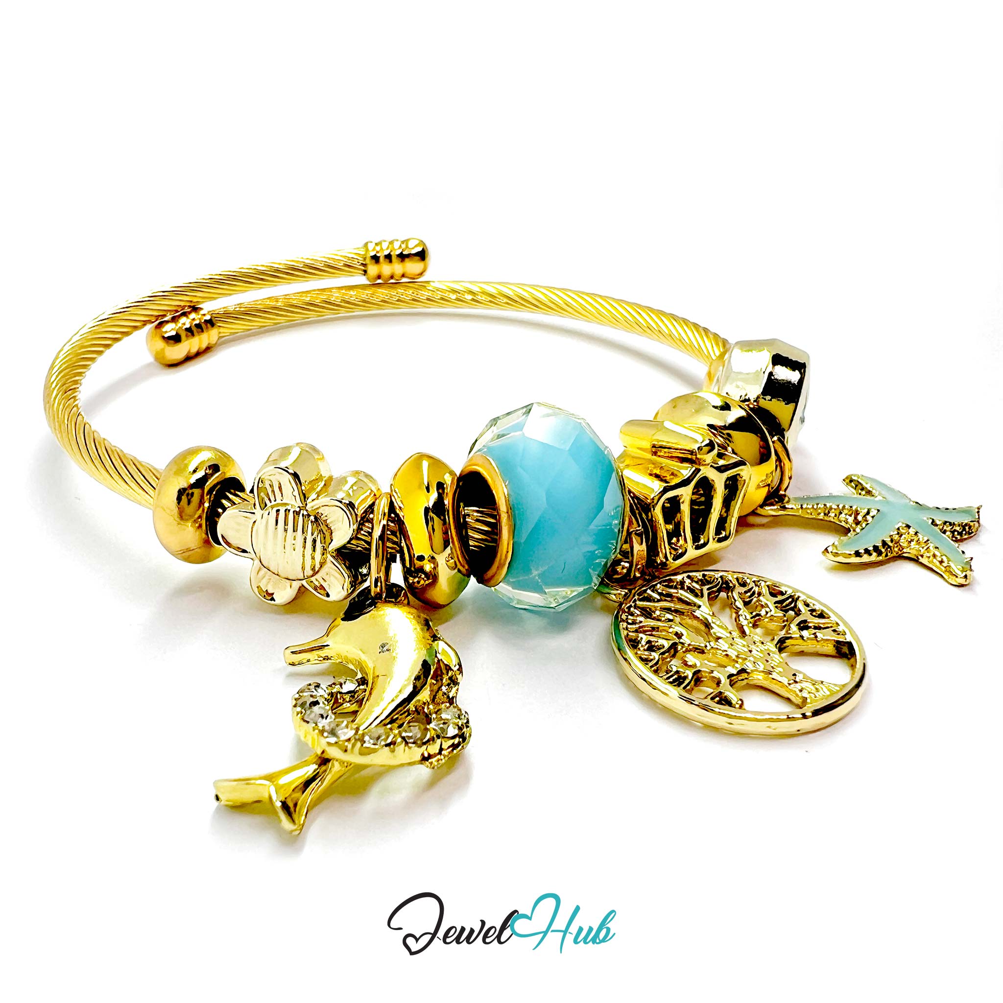 Gold bracelet with various charms including a blue bead, airplane, and others on a white background. Brand 'Jewel Hub' visible.
