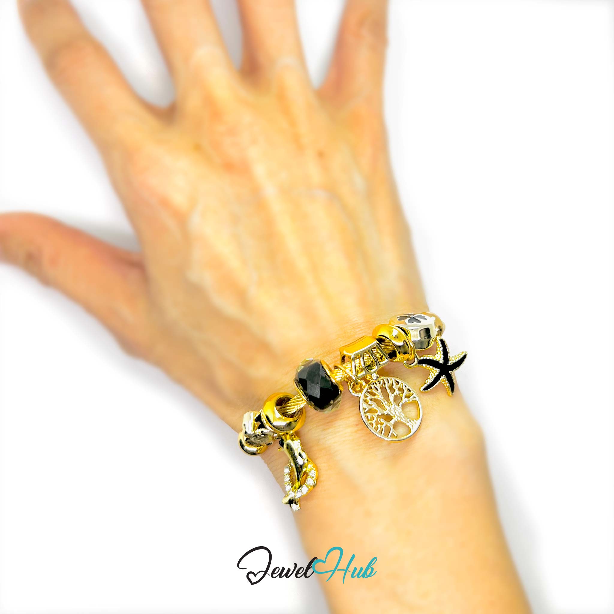 Gold bracelet with charms on a hand against a white background, featuring the brand 'Jewel Hub'.