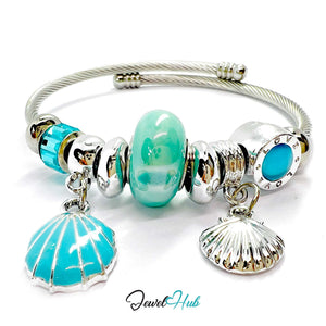 Silver bracelet with turquoise beads and shell charms on a white background, branded 'Jewel Hub'.