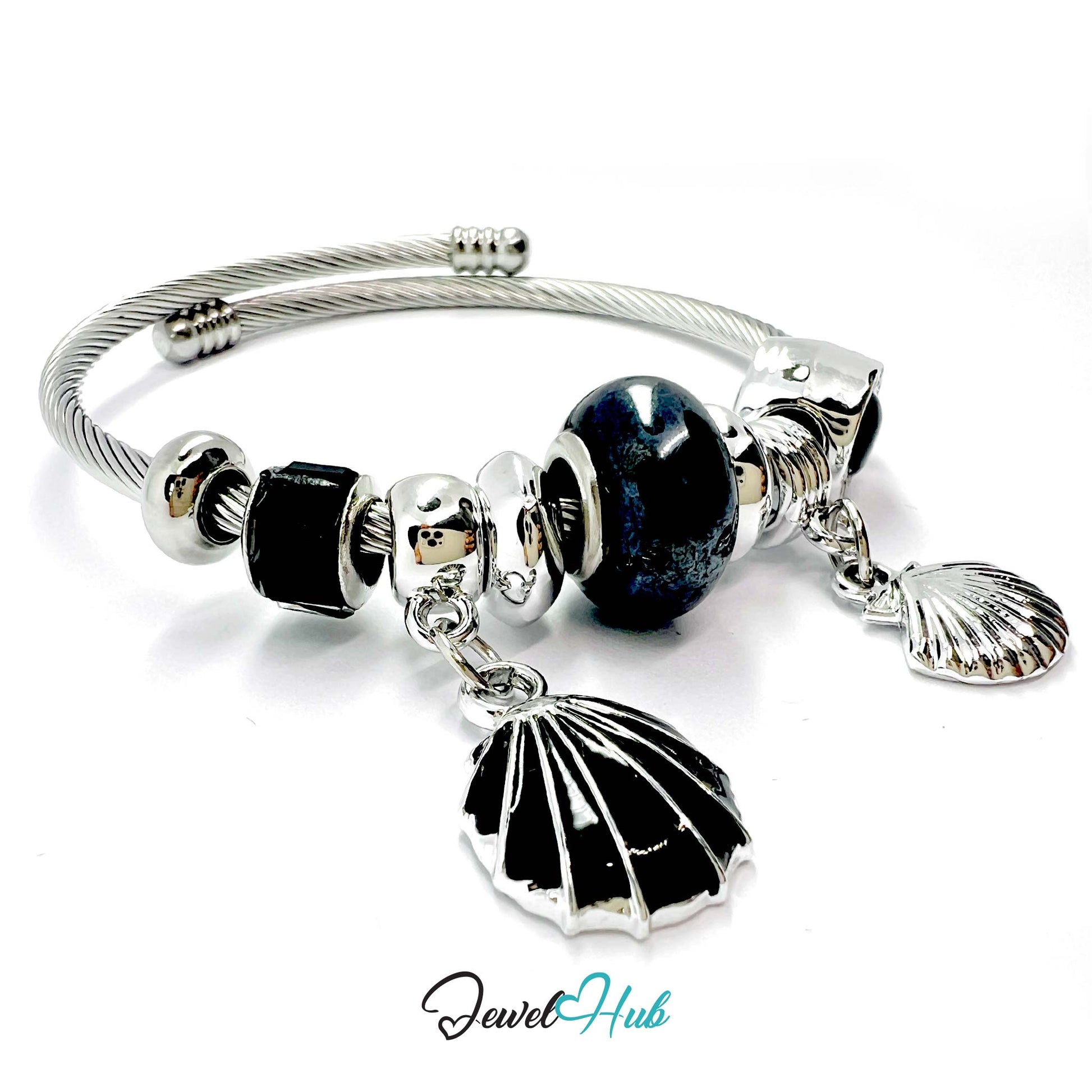 Silver bracelet with black and white beads and shell charms on a white background, branded 'Jewel Hub'.