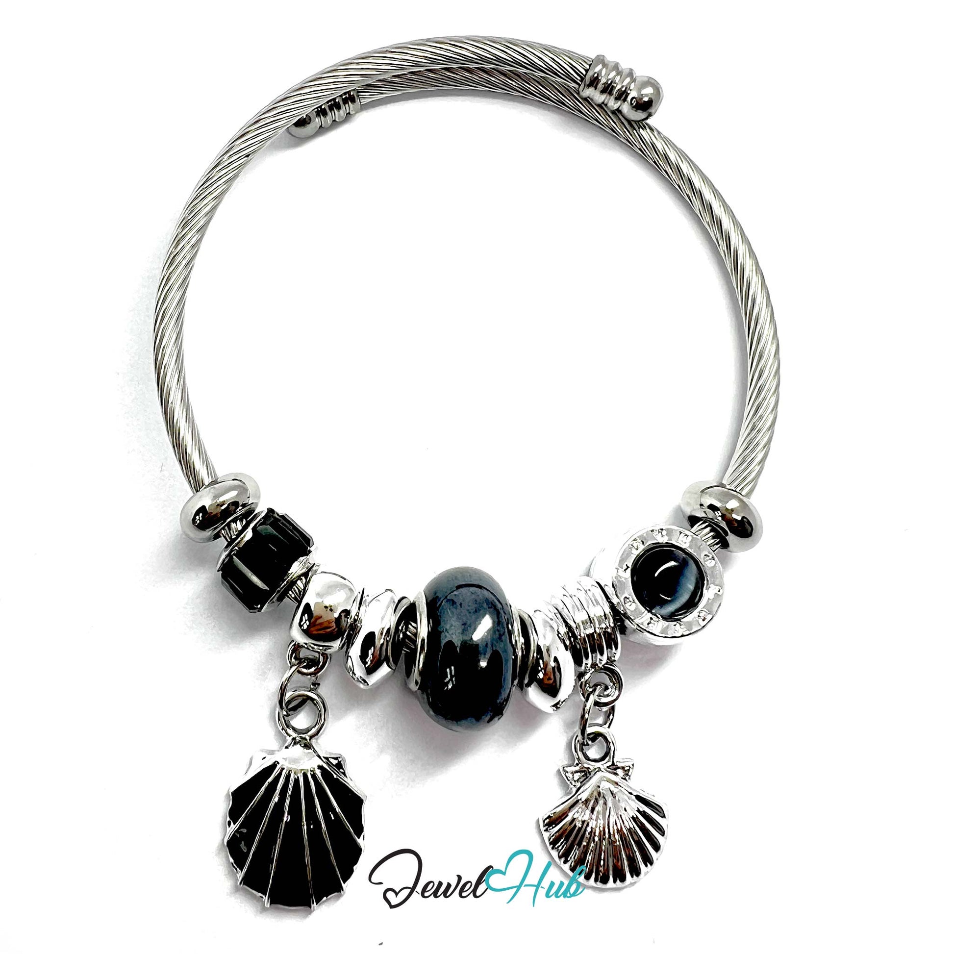 Silver bracelet with black beads and shell charms on a white background