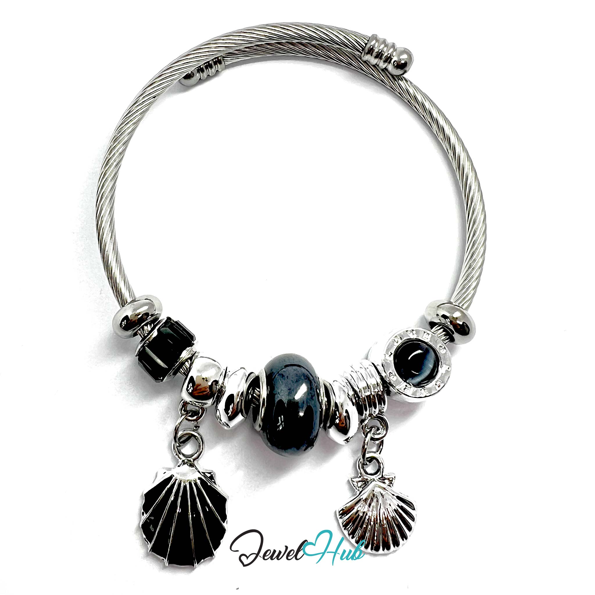 Silver bracelet with black beads and shell charms on a white background