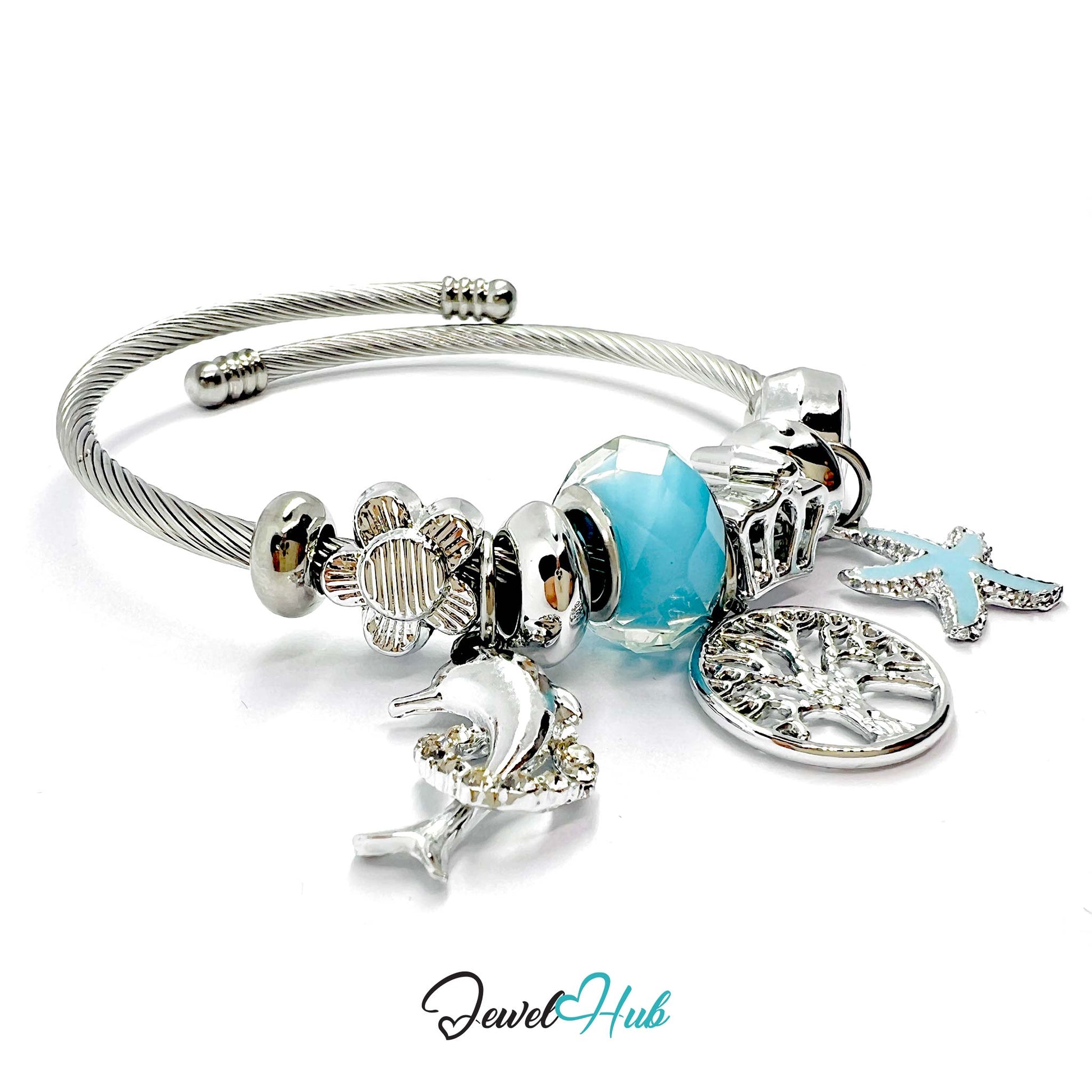 Silver bracelet with charms including a blue heart, starfish, and dolphin on a white background. Brand 'Jewel Hub' visible.
