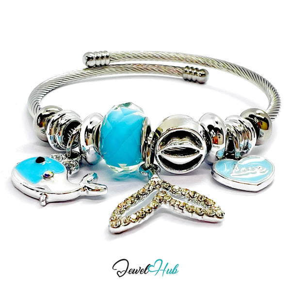 Silver bracelet with cyan beads and charms on a white background,