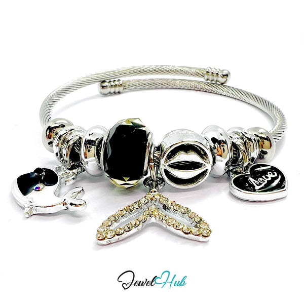 Silver bracelet with various charms on a white background, branded 'Jewel Hub'.