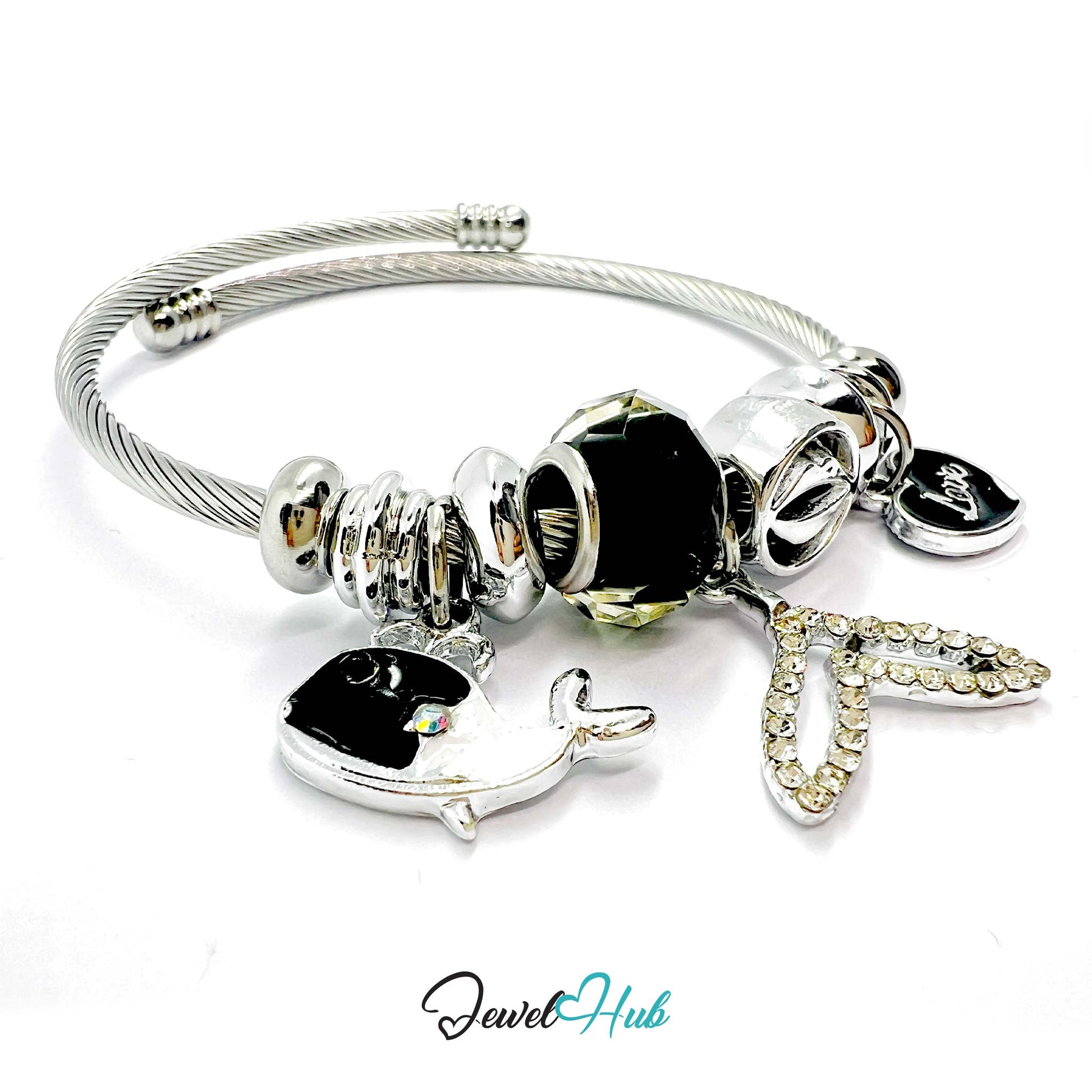 Silver bracelet with black beads and charms on a white background,
