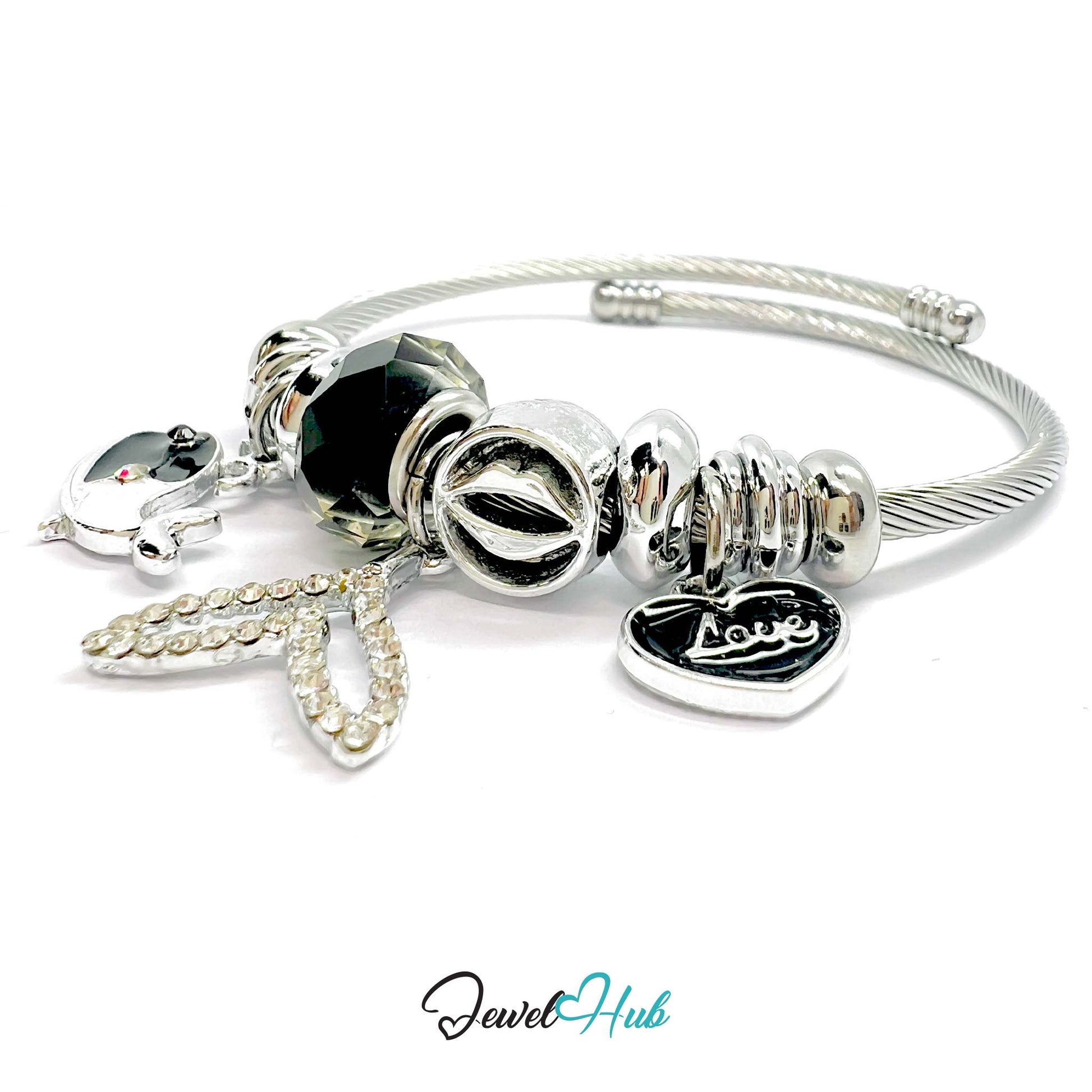 Silver bracelet with black beads and charms on a white background,