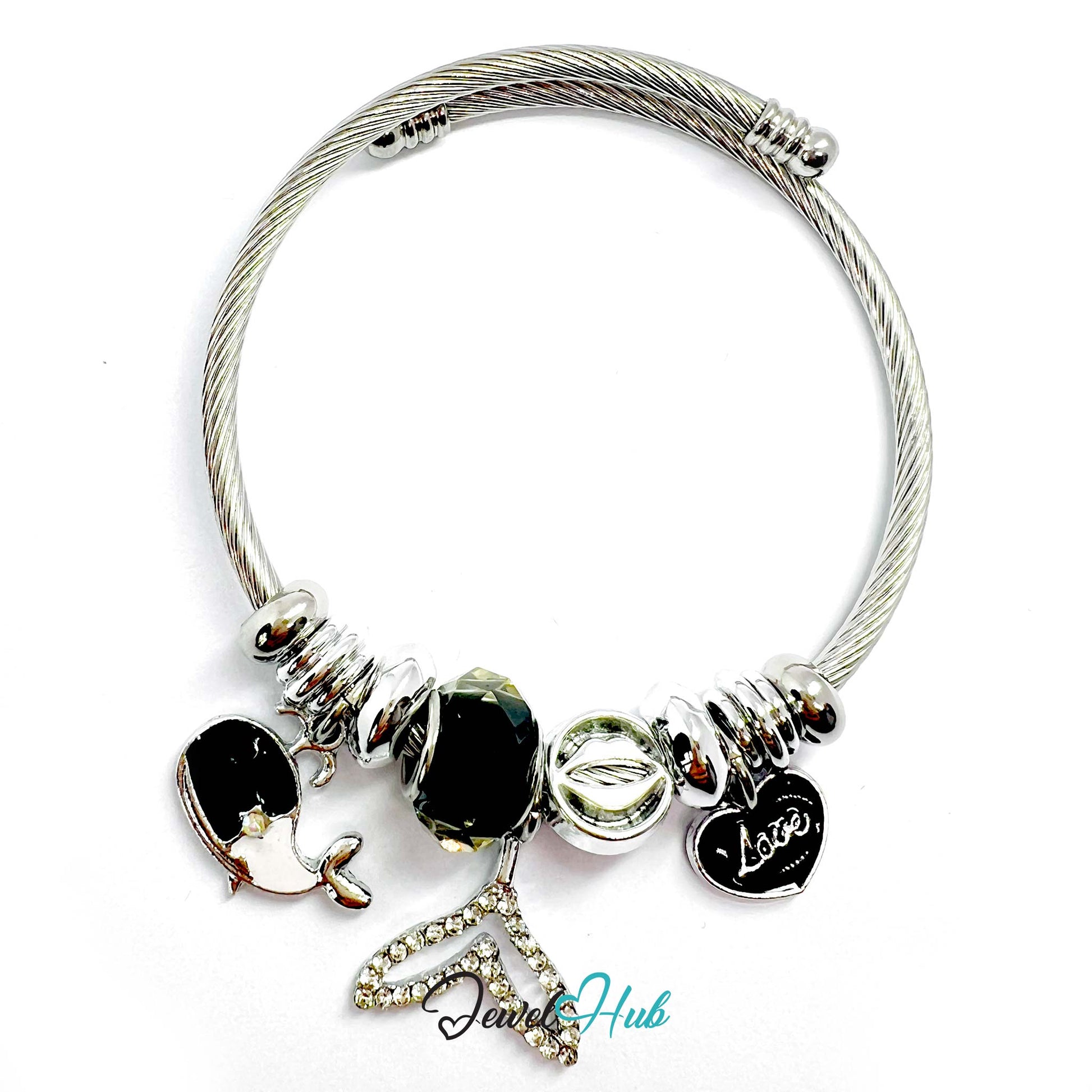 Silver bracelet with various charms on a white background