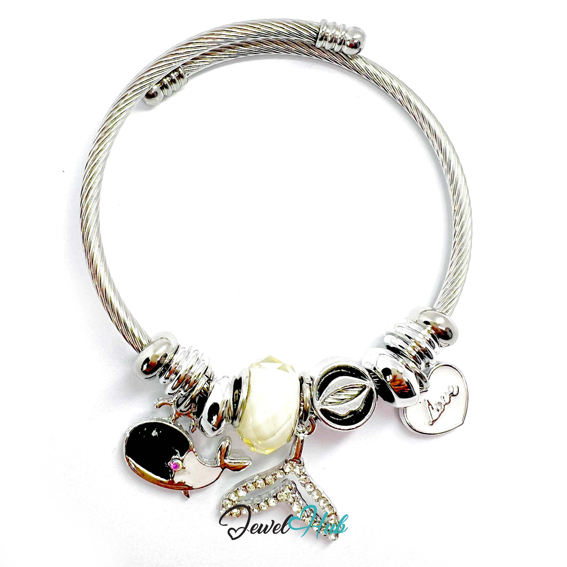 Silver bracelet with various charms on a white background