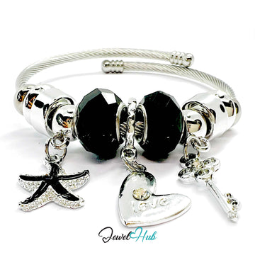 Silver bracelet with black beads and charms on a white background, branded 'Jewel Hub'.