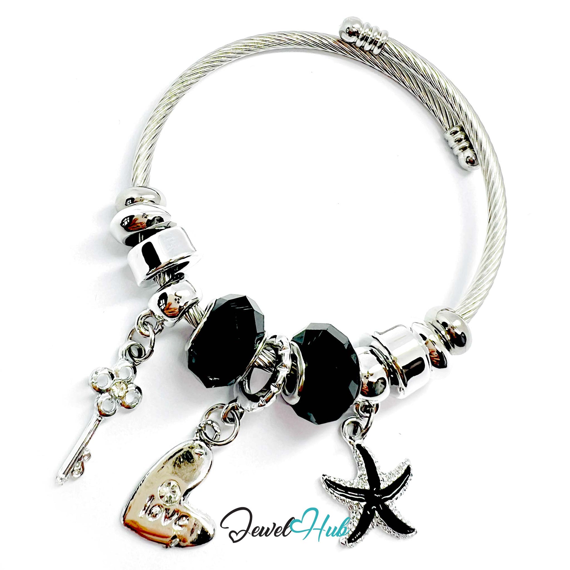 Silver bracelet with black beads and charms on a white background