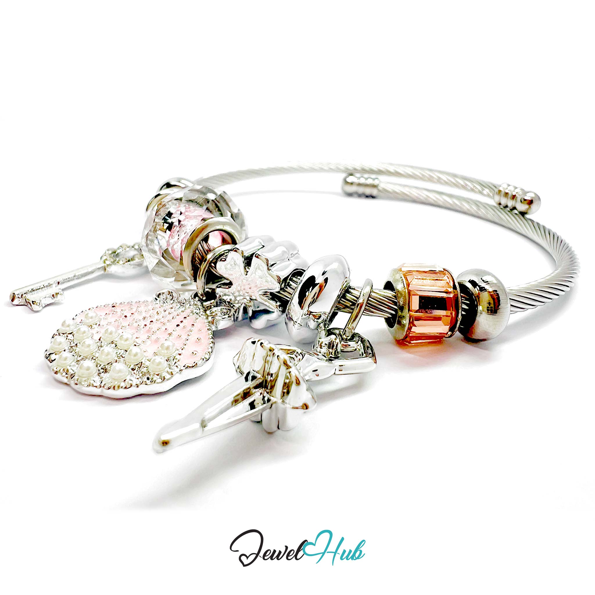Silver bracelet with various charms on a white background