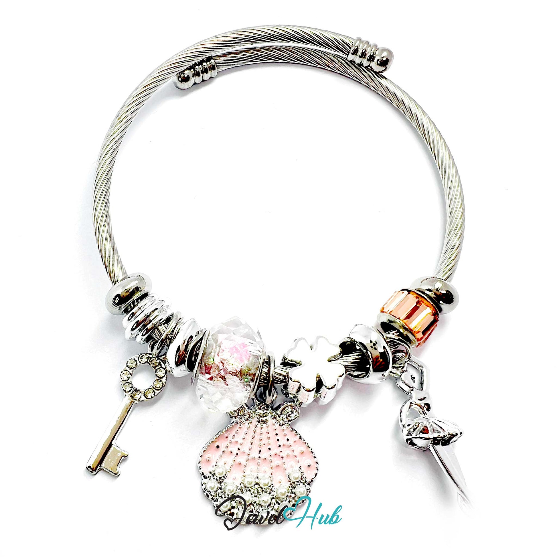 Silver bracelet with various charms on a white background