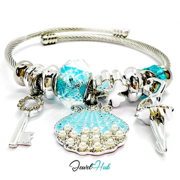 Silver bracelet with blue and clear beads and charms on a white background, featuring the brand 'Jewel Hub'.