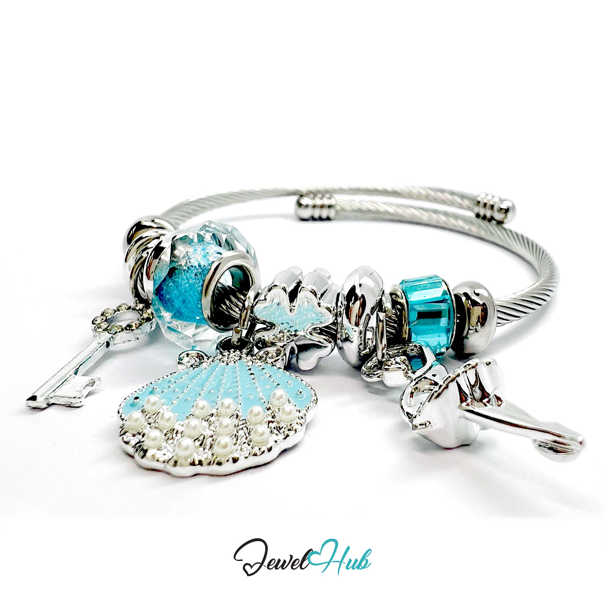 Silver stainless steel charm bracelet with blue and clear beads and charms on a white background
