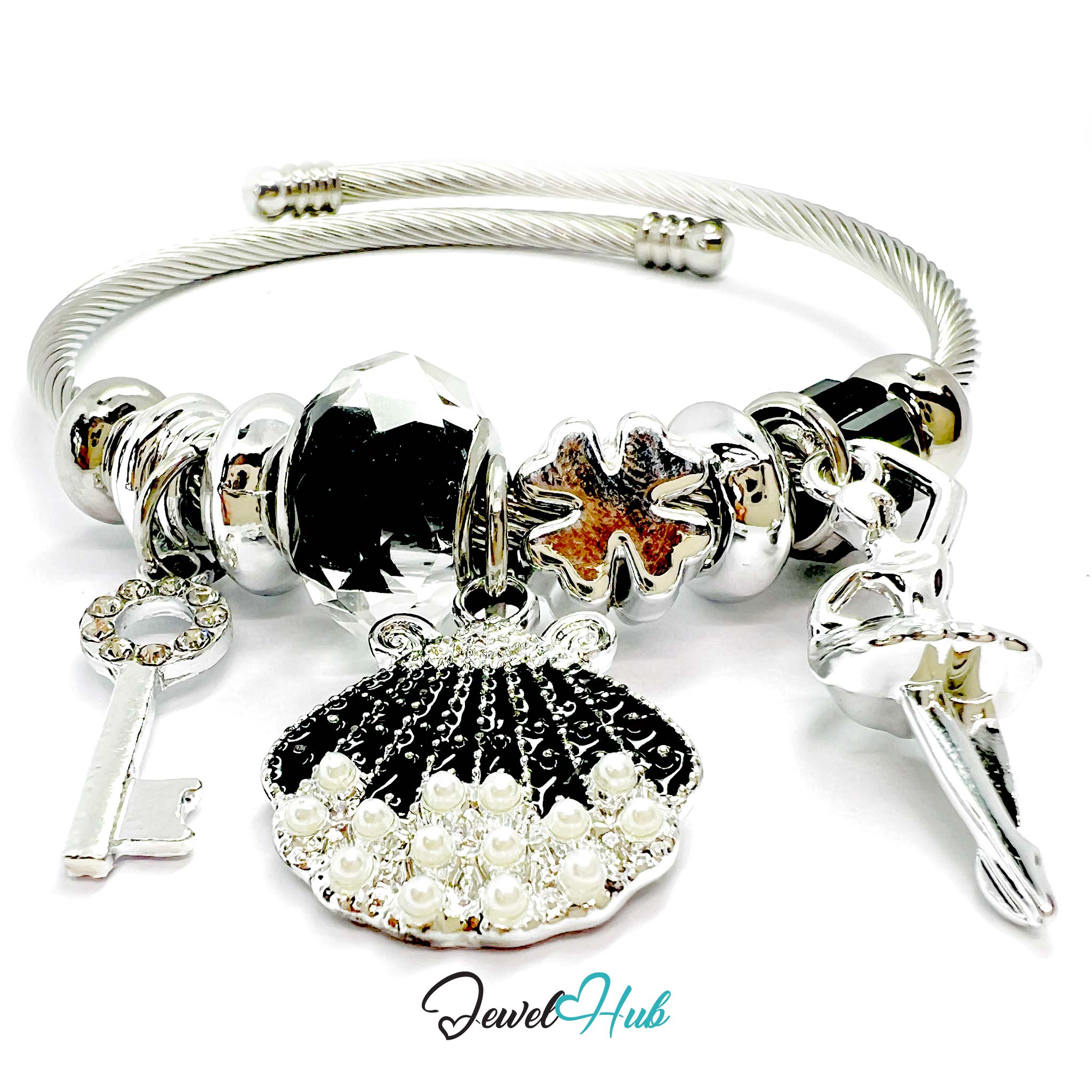Silver bracelet with various charms including a shell, key, and starfish on a white background.