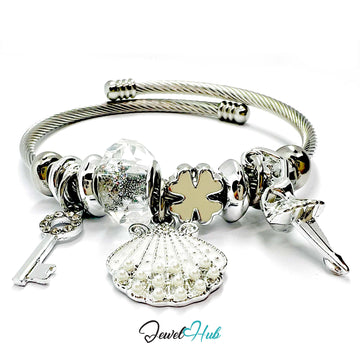 Silver bracelet with various charms on a white background, branded 'Jewel Hub'.