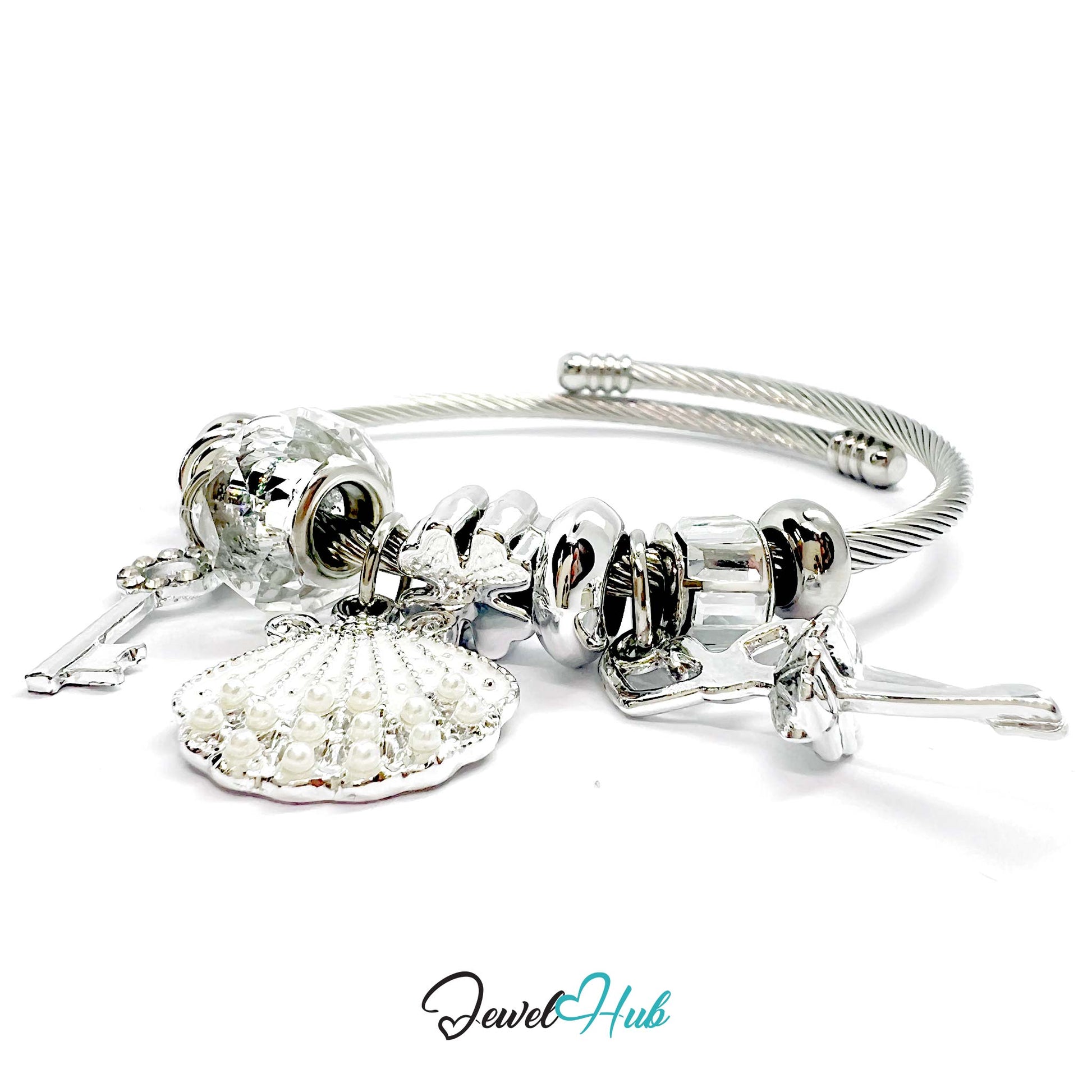 Silver stainless steel charm bracelet with white and clear beads and charms on a white background