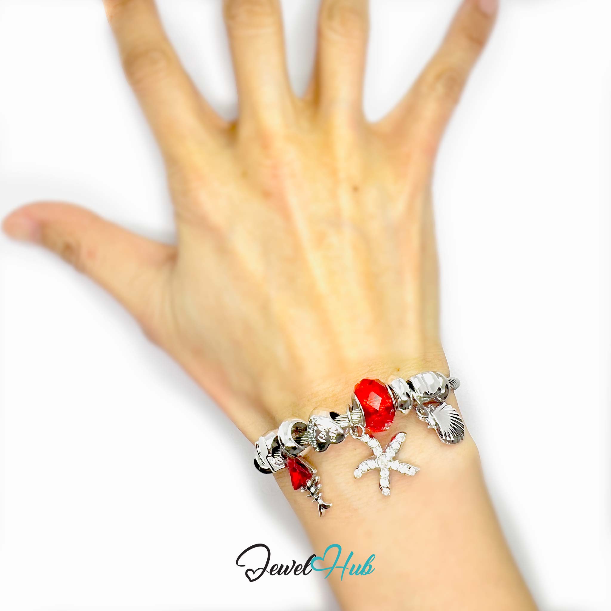 Bracelet with various charms on a hand against a white background, branded 'Jewel Hub'.