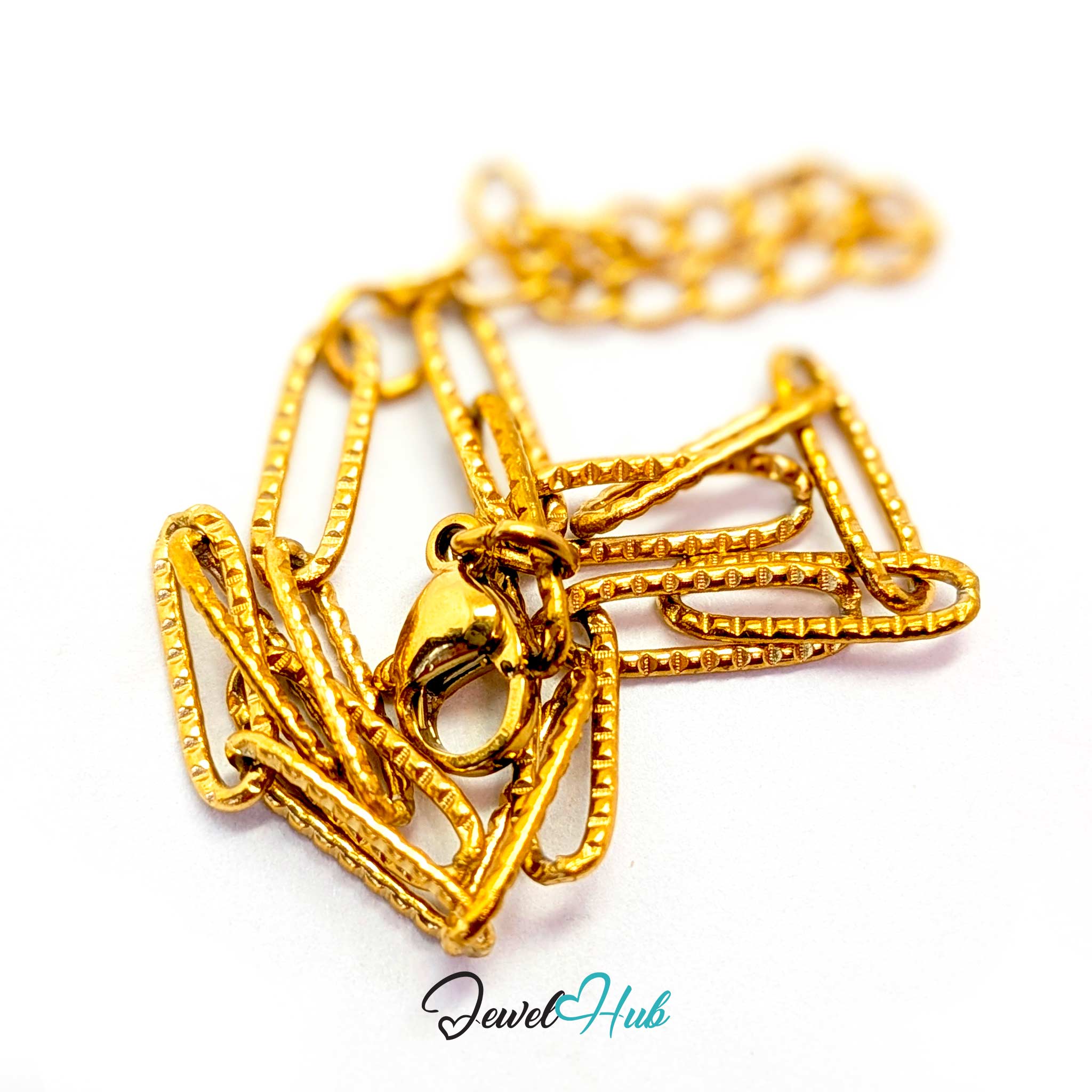 A close-up of a gold-toned chain necklace with a textured, layered paperclip-style pendant clasp, shown on a white background with a 'JewelHub' watermark at the bottom.