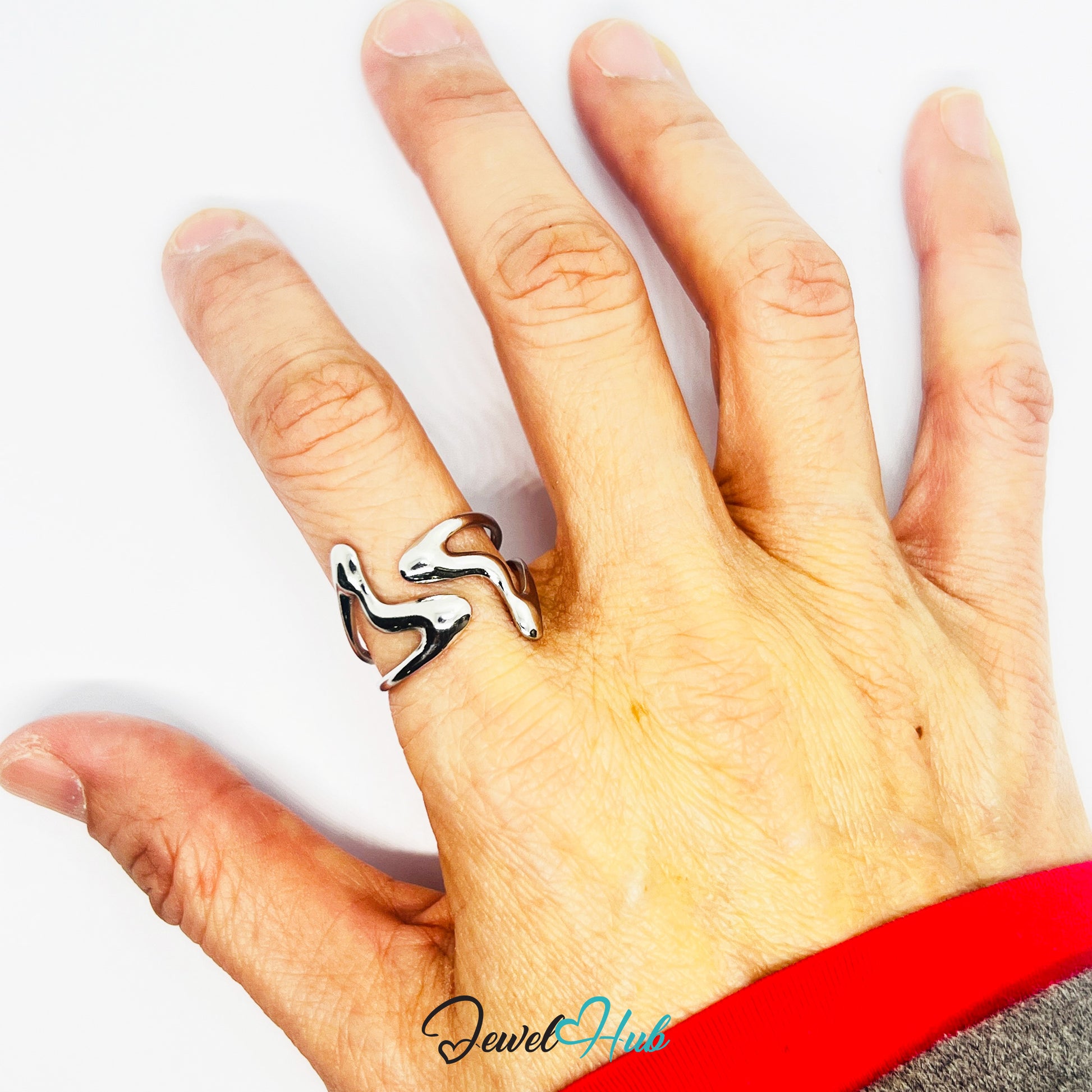 Hand wearing a silver ring with a white background