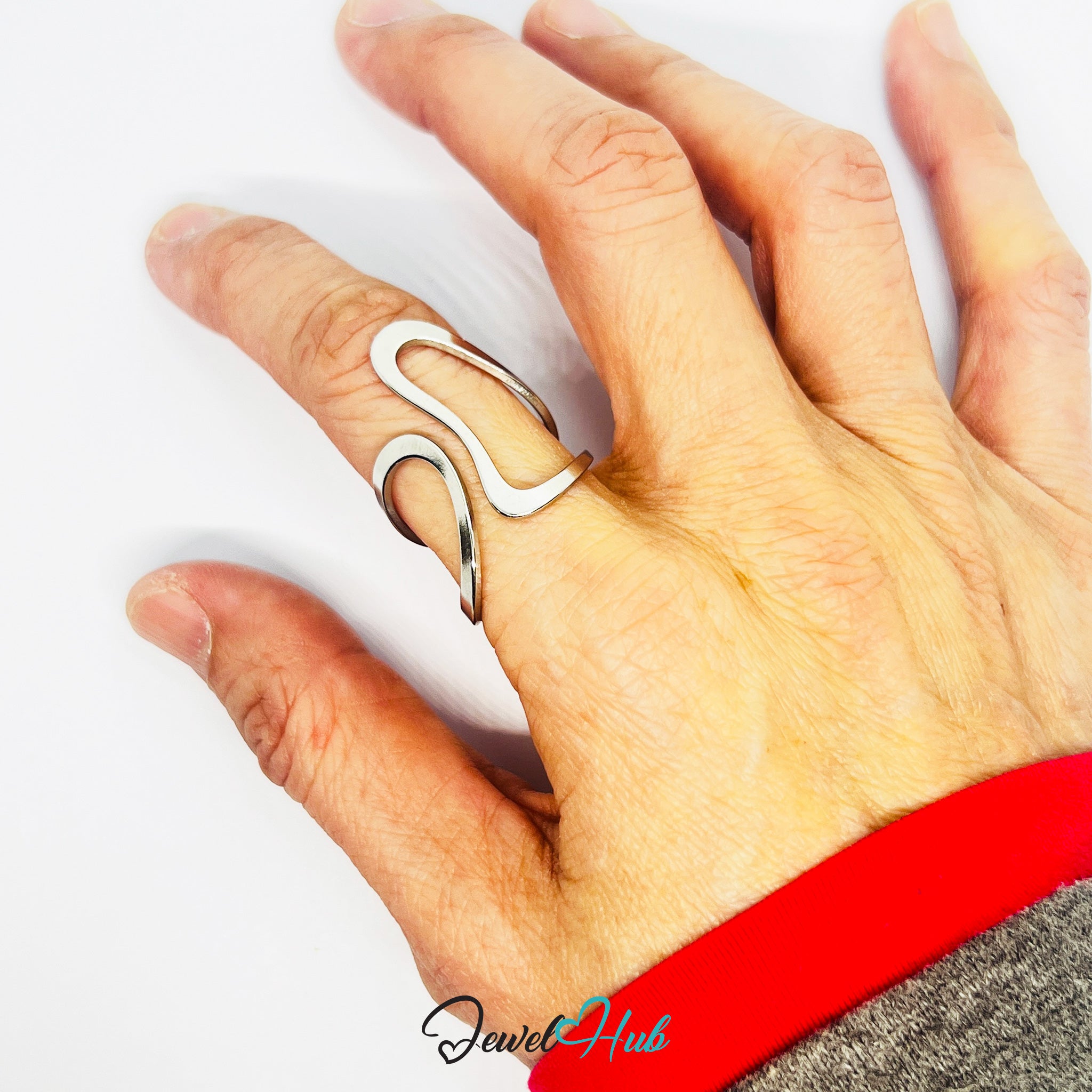 Hand wearing a silver ring with a unique design on a white background, featuring the brand 'Jewel Hub'.