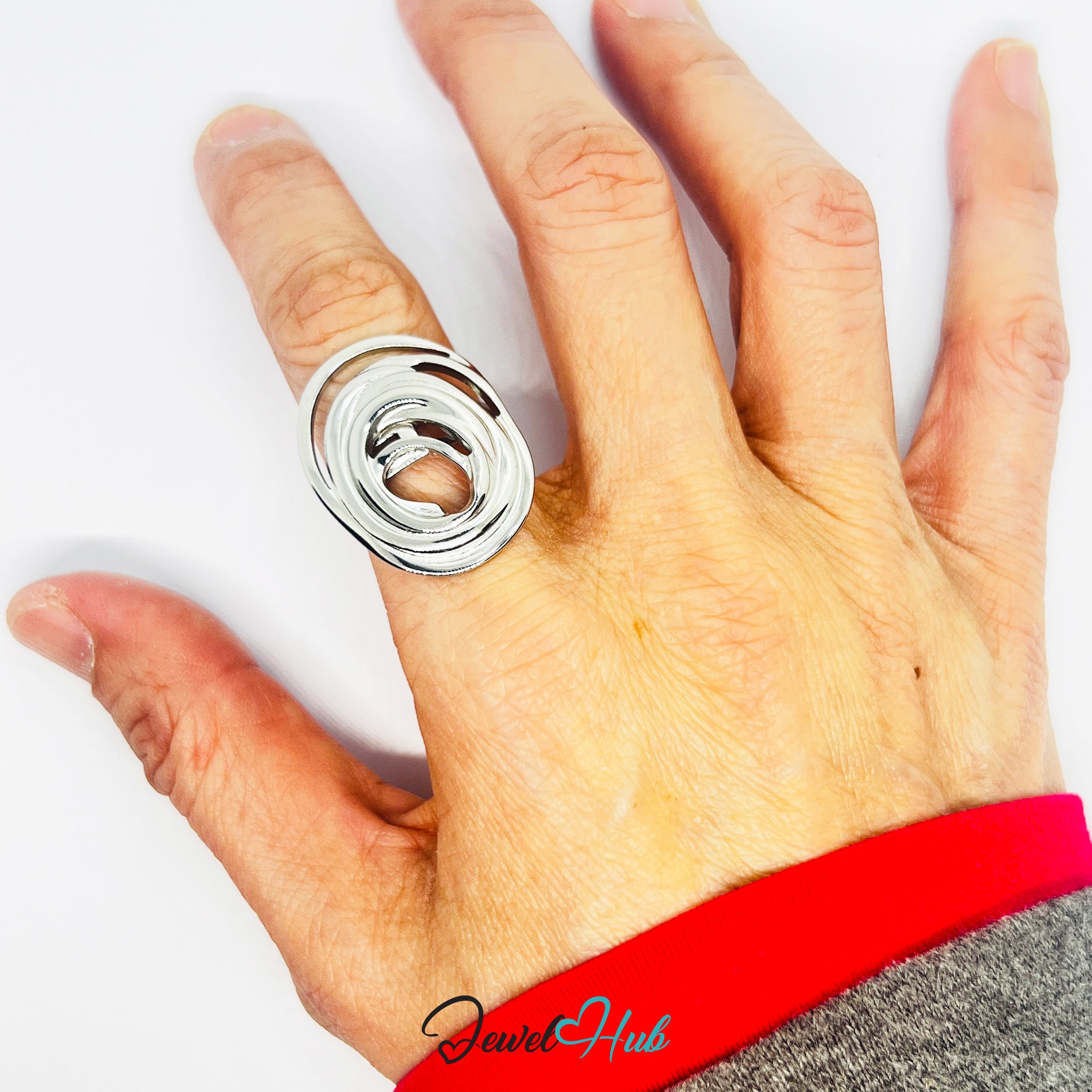 Hand wearing a silver ring on a white background with 'Jewel Hub' branding.