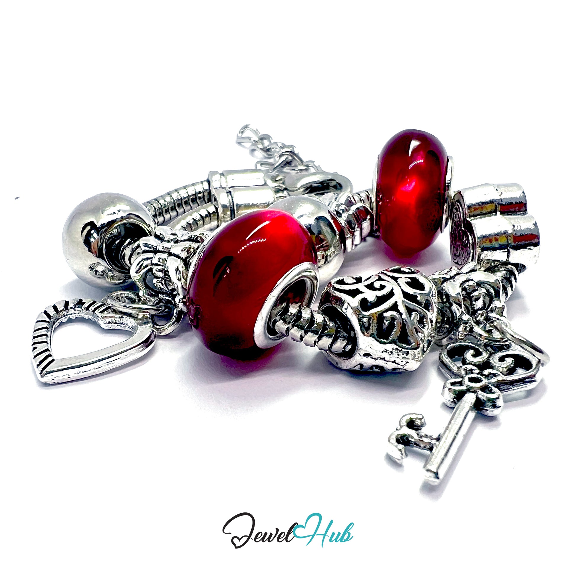 Silver bracelet with red beads and charms on a white background, branded 'Jewel Hub'.